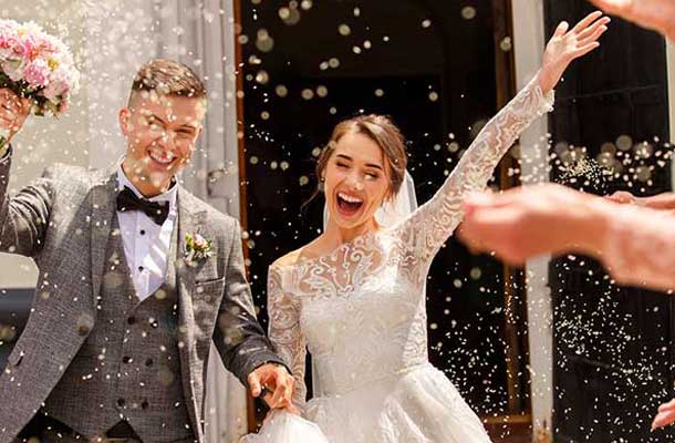 bride and groom with rice thrown